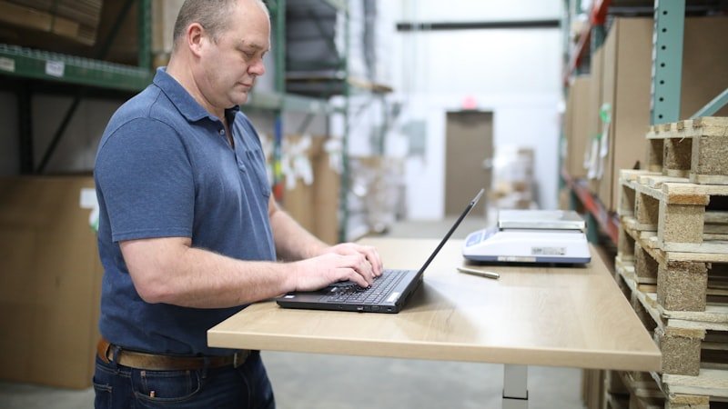 Operations staff member checking dispatch schedule on a laptop